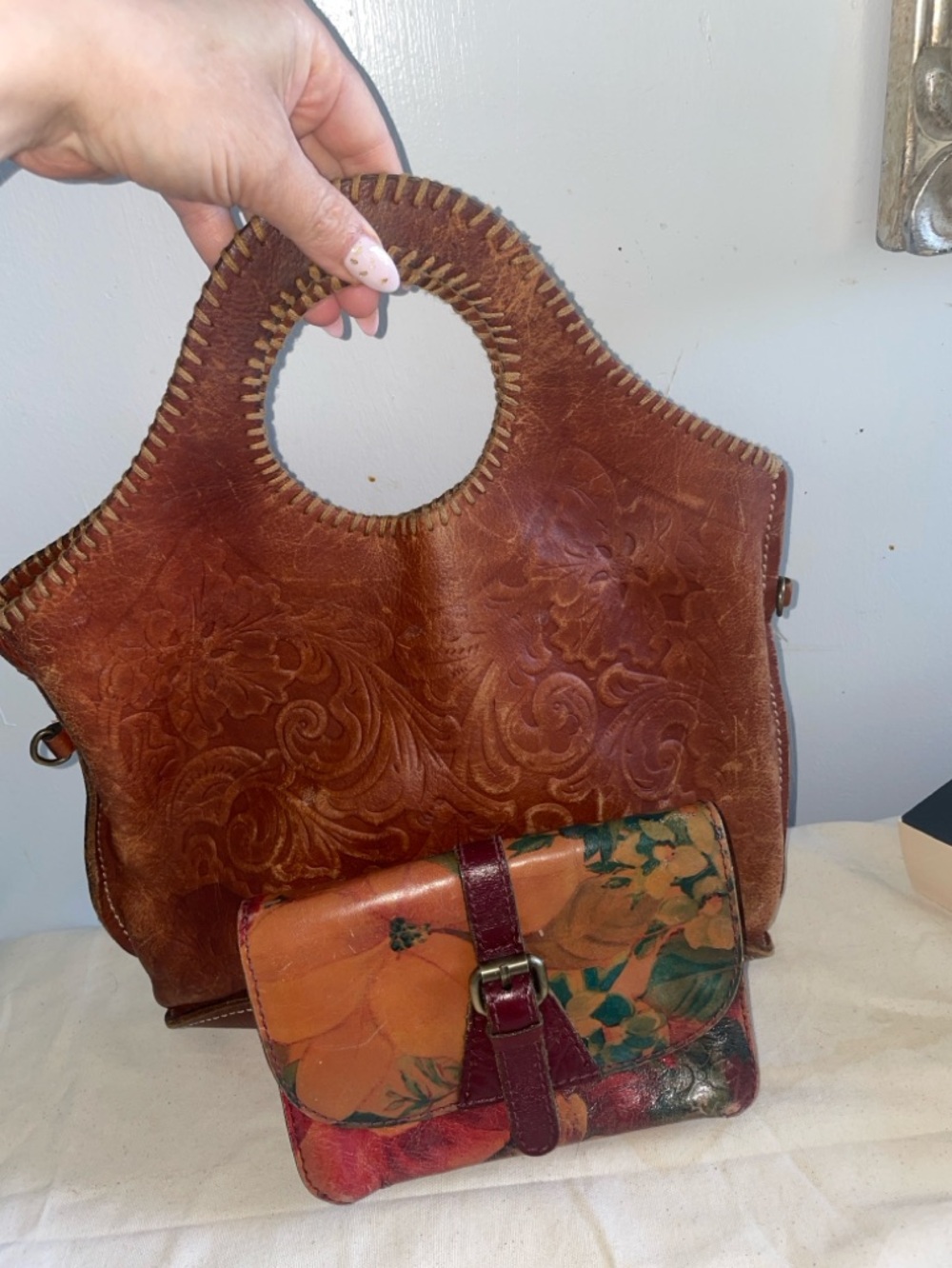 Patricia Nash brown leather tote bag paired with a colorful floral wallet